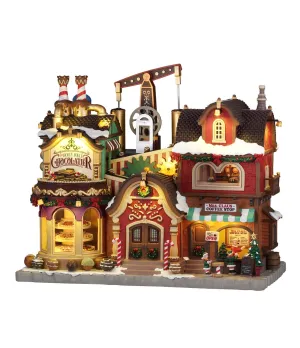 Lemax The Holly Jolly Chocolatier & Mrs. Claus Coffee Stop 65521: fabbrica di cioccolato illuminata con caffetteria